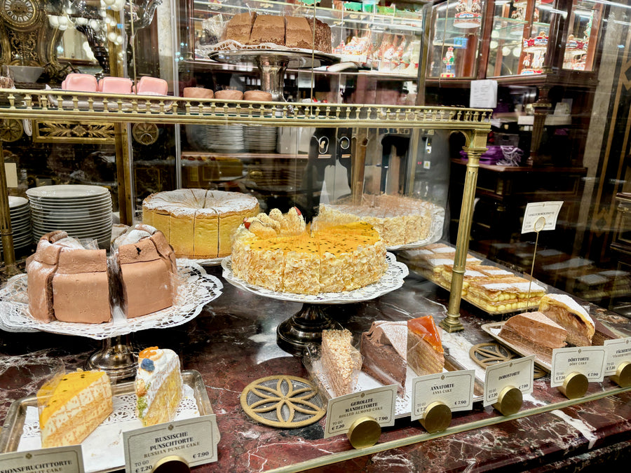 Bakery display case filled with assorted cakes and pastries.